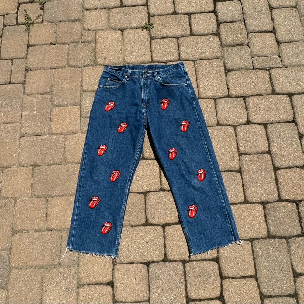Vintage wrangler blue jeans with custom rolling stone patches, size is 34 X29
